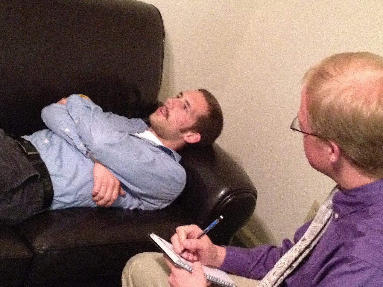 Two adults seated across from each other during a serious conversation